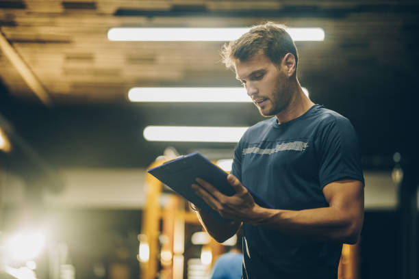 Fitness coach analyzing biomarker data for data-driven personal training