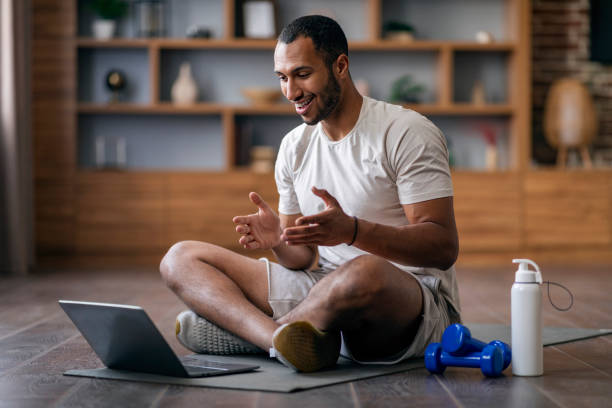 Trainer providing virtual coaching to a man for ongoing fitness guidance