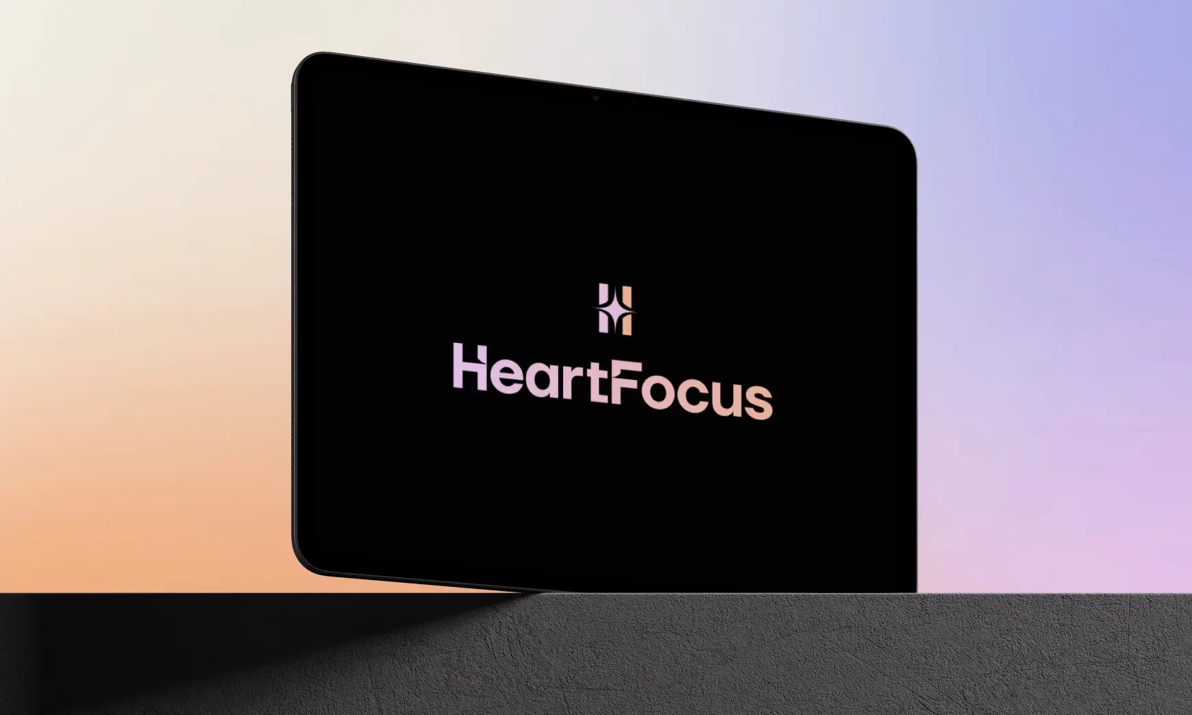 The HeartFocus logo on a tablet screen