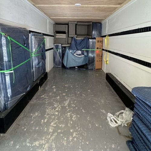 Moving truck neatly packed with furniture wrapped in protective blankets by Texas Delta Moving, a trusted moving company in Texas.