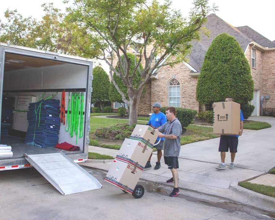 Texas Delta Moving team efficiently loading a moving truck with labeled boxes during a residential move, providing professional and reliable moving services in Texas.