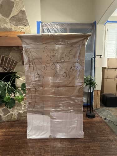 Securely wrapped and labeled glass cabinet during residential moving by Texas Delta Moving, a professional moving service in Texas.