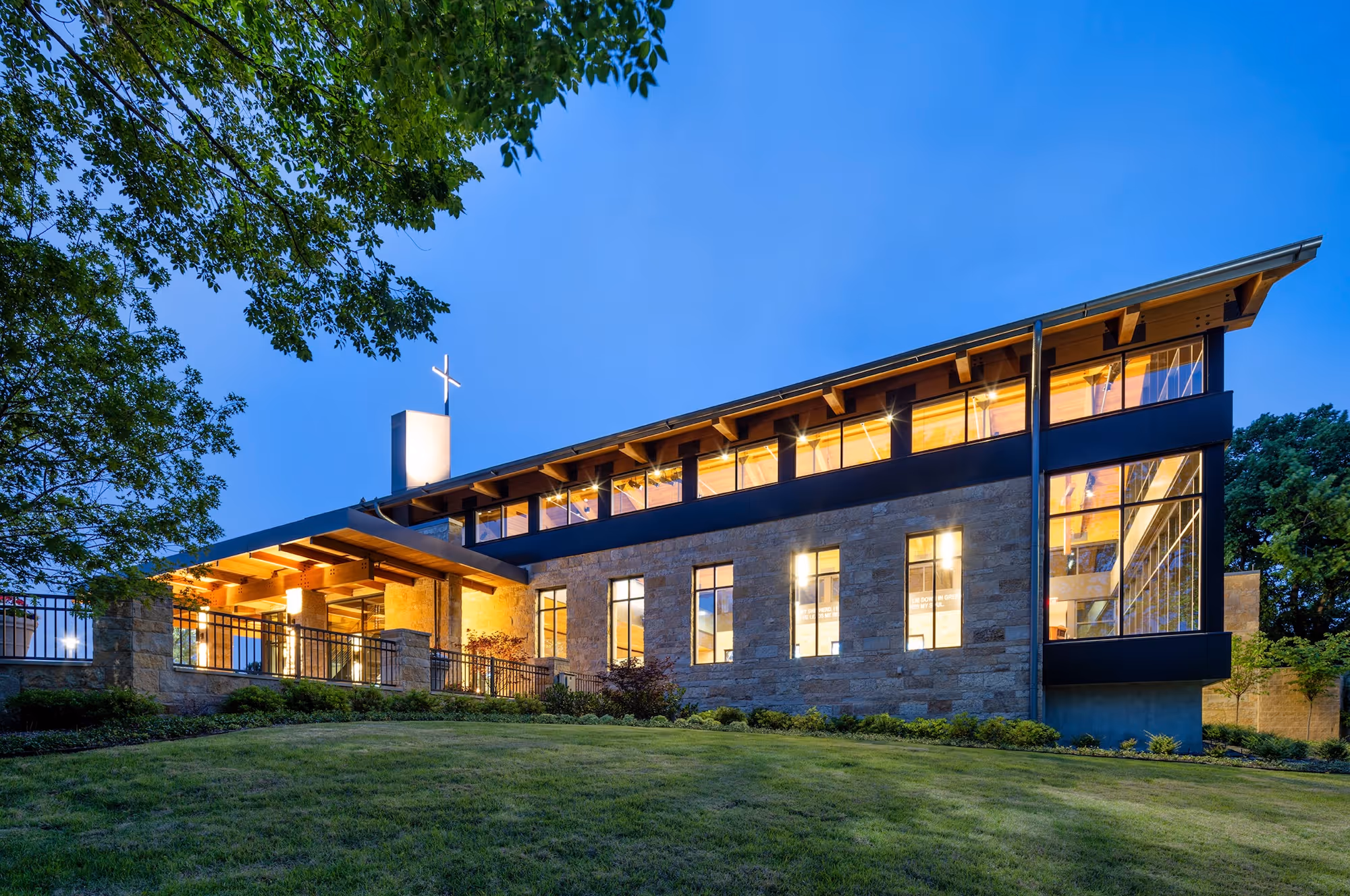 Modern church building exterior at dusk with warm lighting