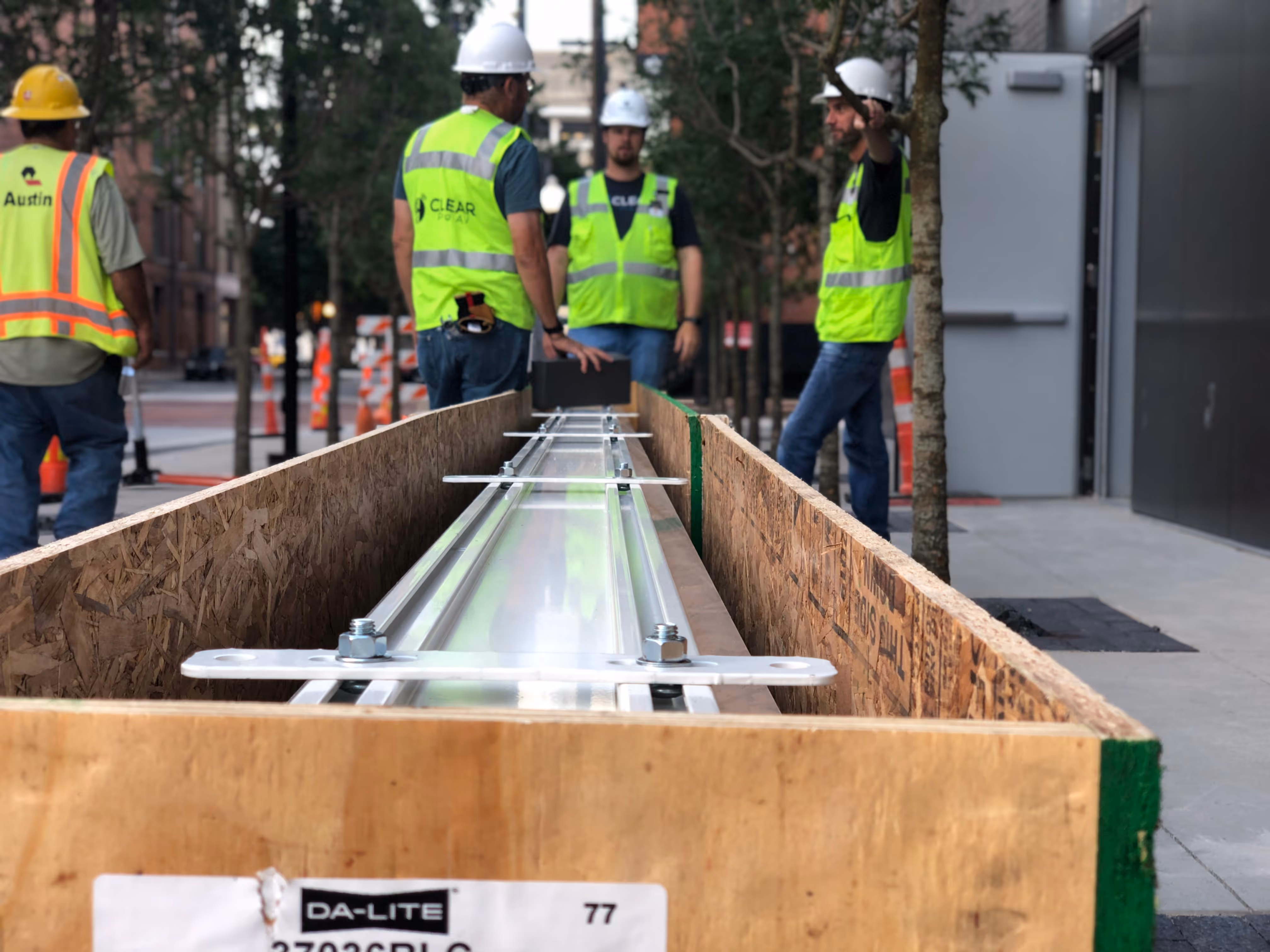 Clear Pro AV installation team transporting large AV equipment crate