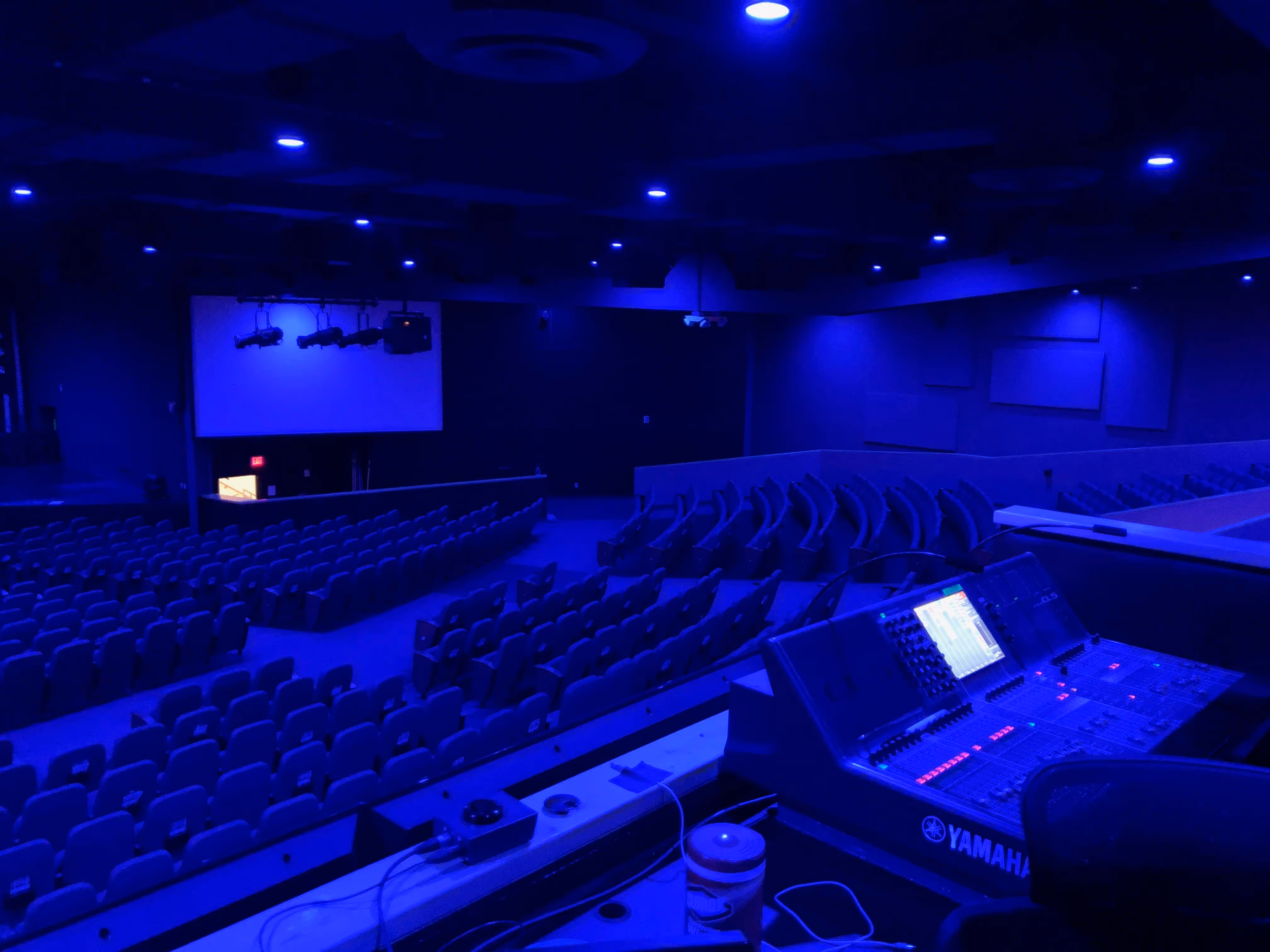 Worship auditorium with Yamaha mixing console and blue stage lighting