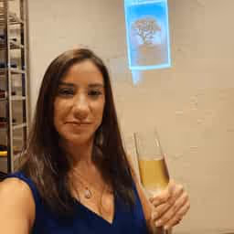 Avatar image of a woman in a black dress holding a champagne flute.