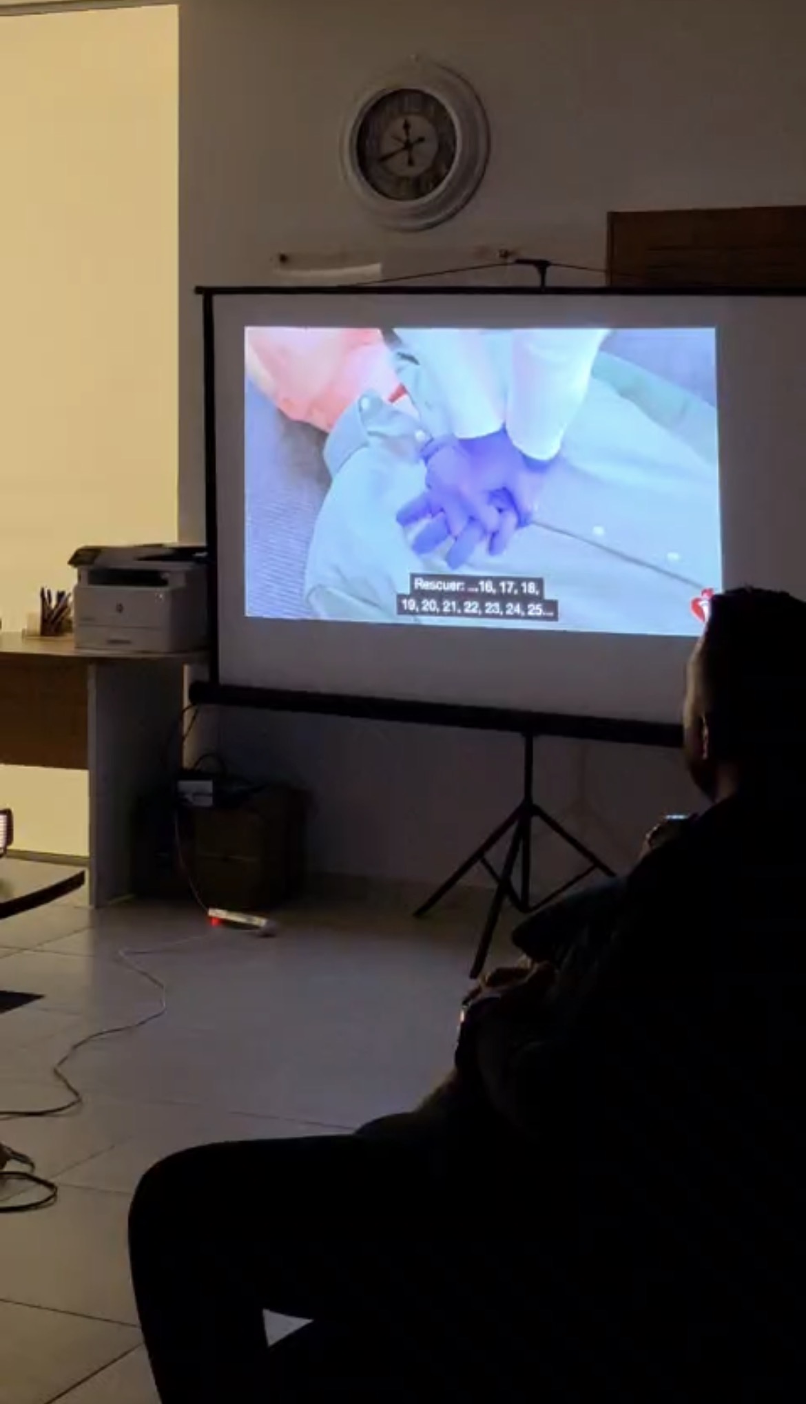 A CARDIG member studying a projected clinical case during a training session