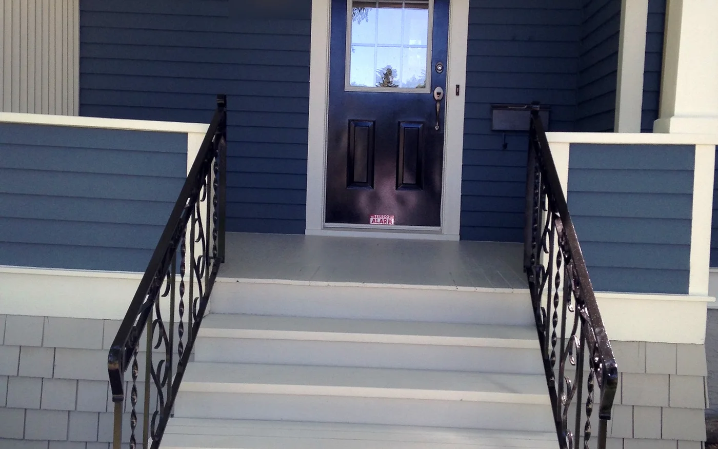 Painted front steps, metal railings and entry door in Edmonton