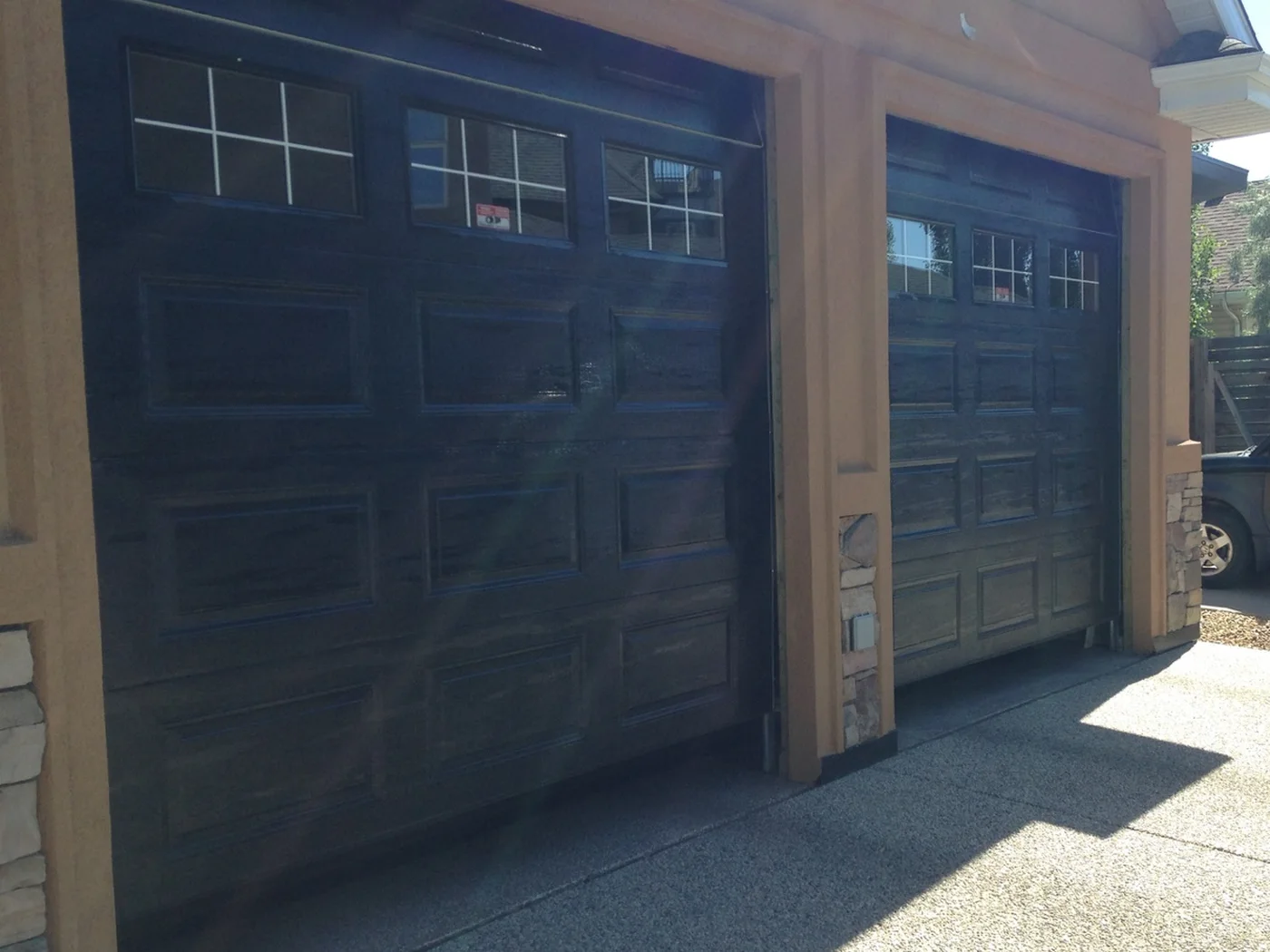 Finished black two-car garage doors on an Edmonton home