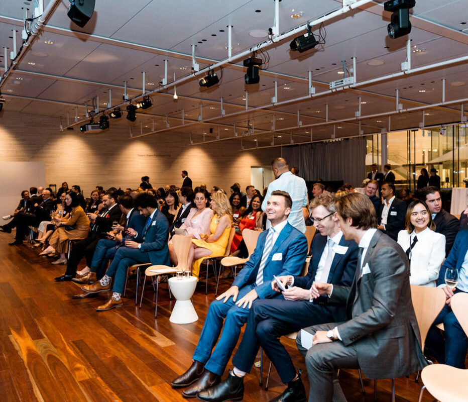 Finance leaders seated and laughing during a session