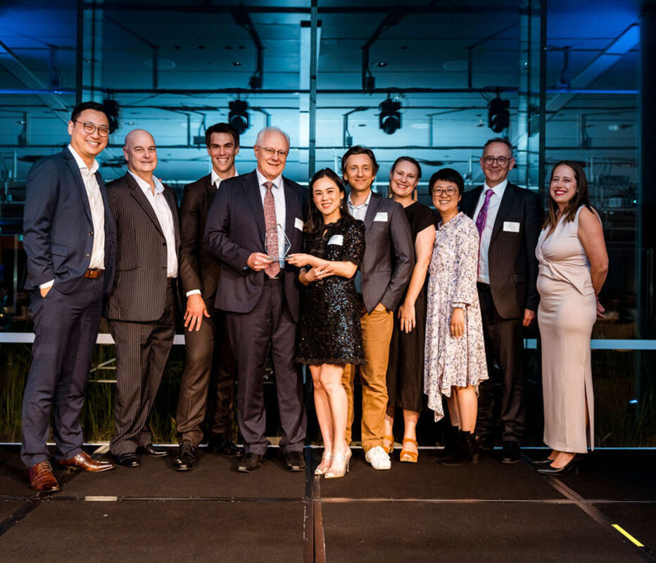 A finance team on stage holding their award