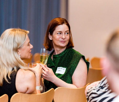 Two finance leaders talking over a drink