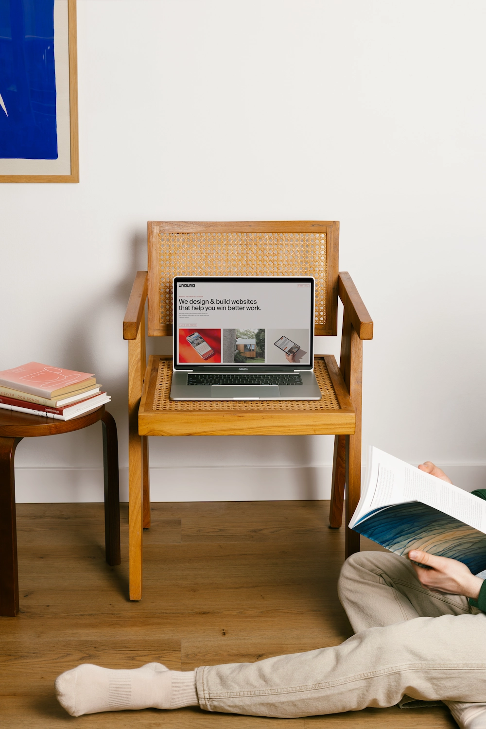 Laptop on wooden chair showing a website about designing and building websites to improve work.