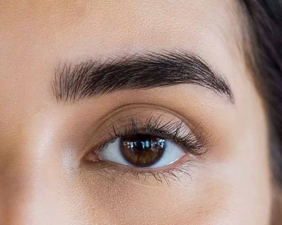 A close up of a woman's brown eye.