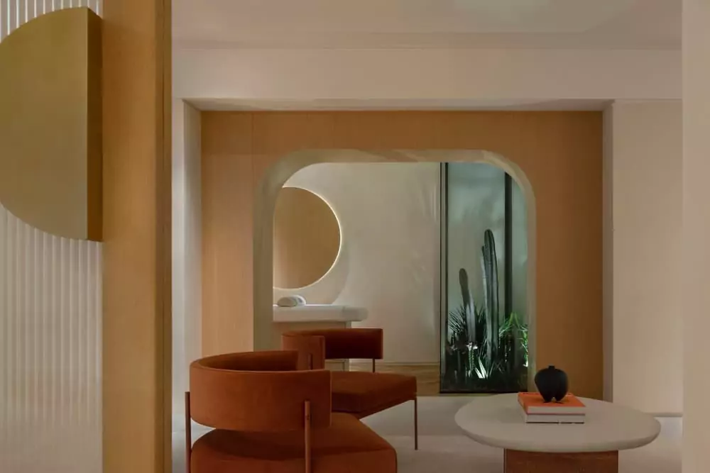 A room with a table, chairs, and a mirror.