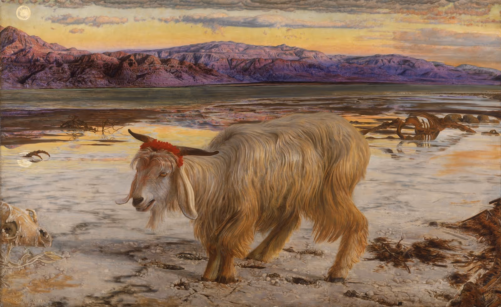 A landscape image of a painting called The Scapegoat by William Holman Hunt. At the centre is a long pale haired goat with a red ribbon wrapped around its horns. The goat is in a desolate snowy landscape; animal skeletons are scattered around and rocky mountains rise into the background in deep shades of purple before a yellow and orange sky.