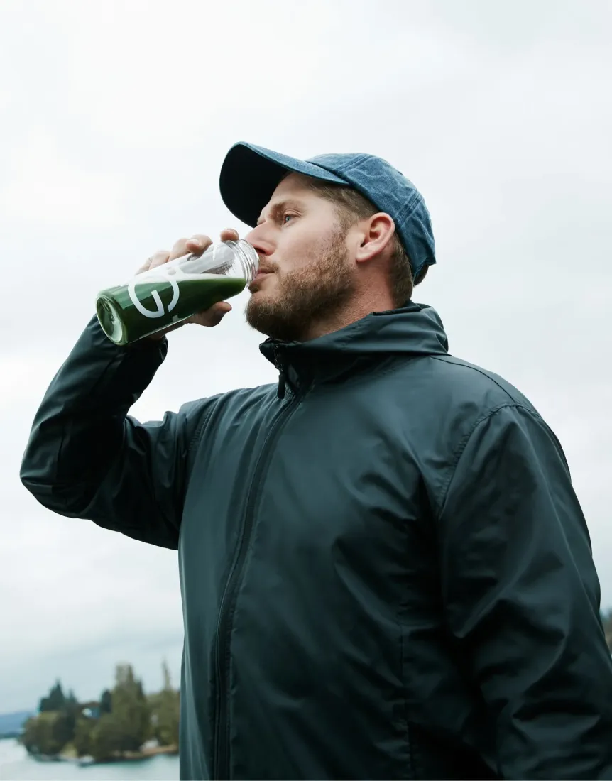 A man drinking green juice.