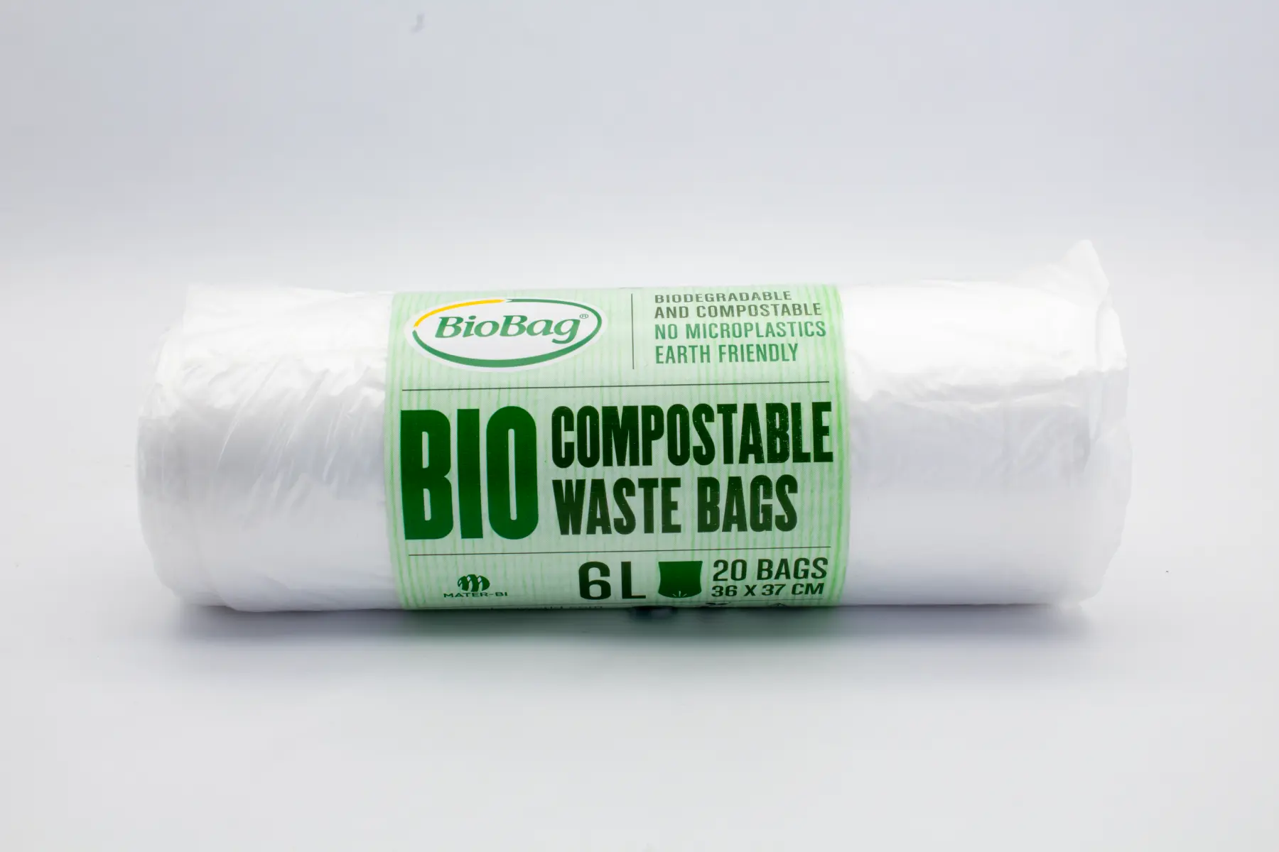 Green and white doubleside printed paper banderole on a roll of BioBag waste bags.