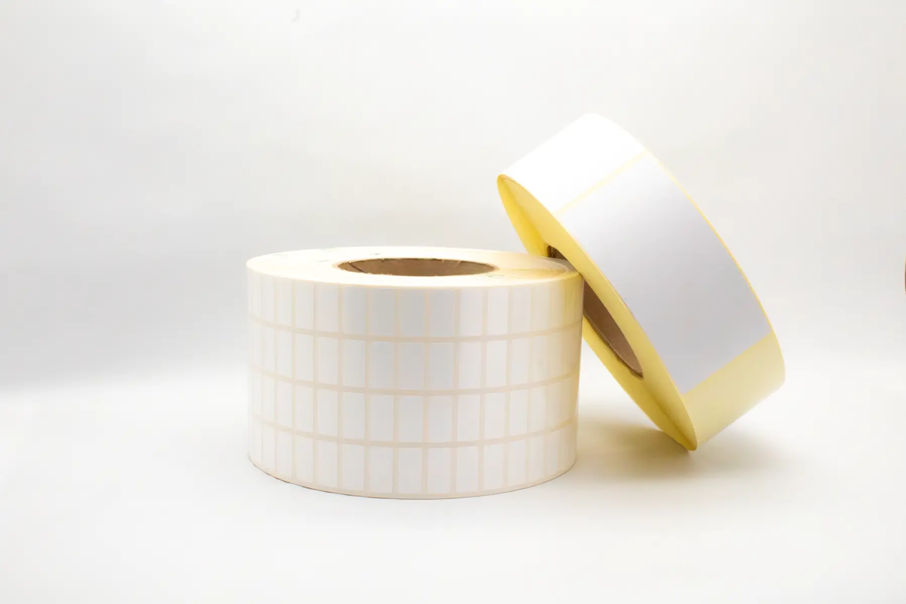 White blank thermal label rolls for shipping and logistics barcode printing.