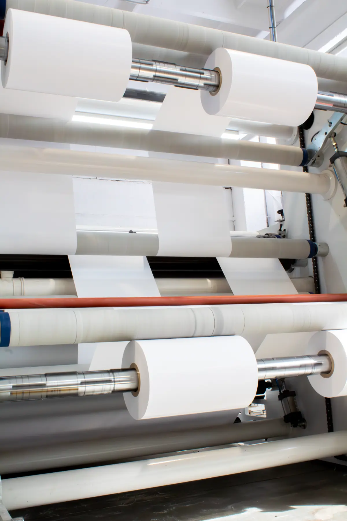 Close-up of the barrier coating application process on flexible packaging web materials.