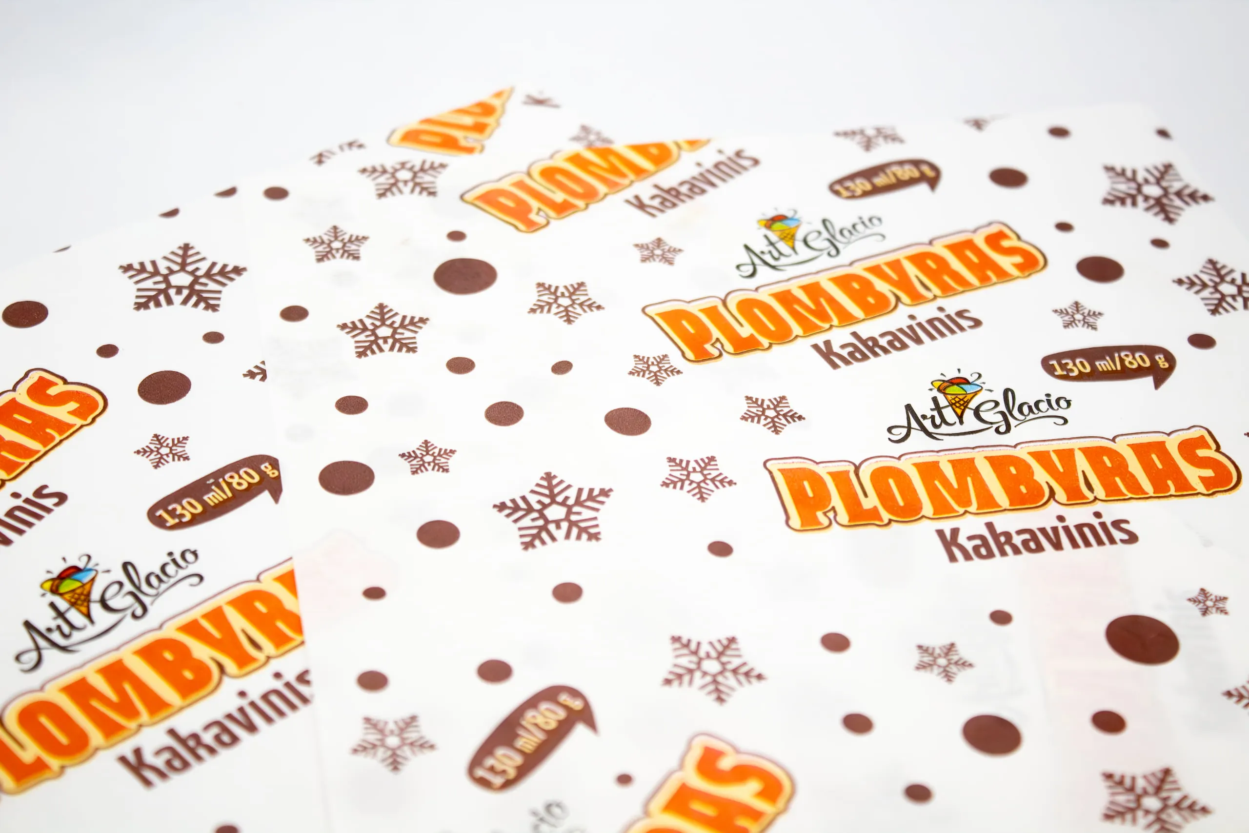 White wrapping paper sheets featuring a repeated custom logo pattern for retail or food presentation.