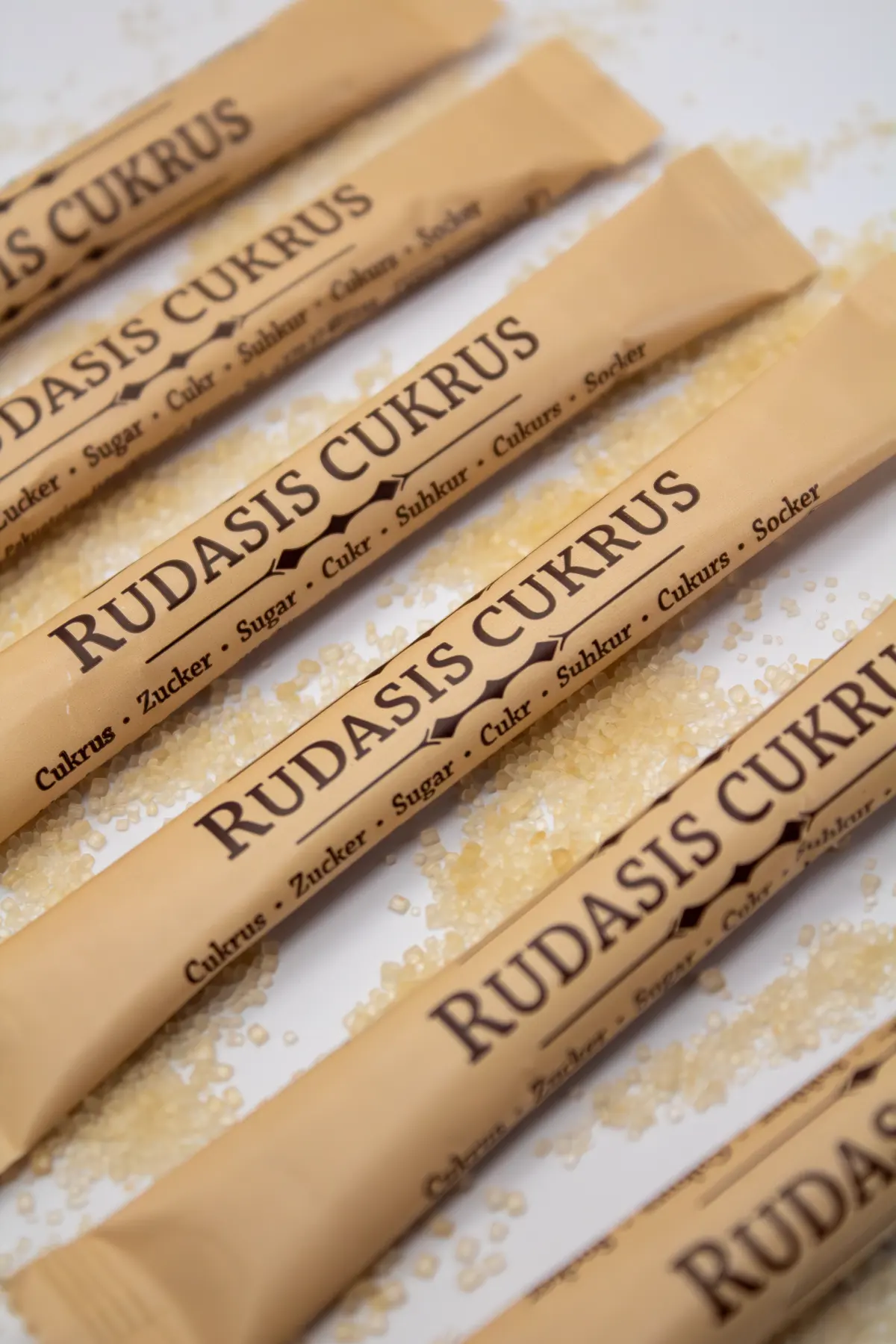 Recyclable paper sugar sticks produced on high-speed VFFS lines, demonstrating excellent tearability and seal integrity replacing PE-coated paper.