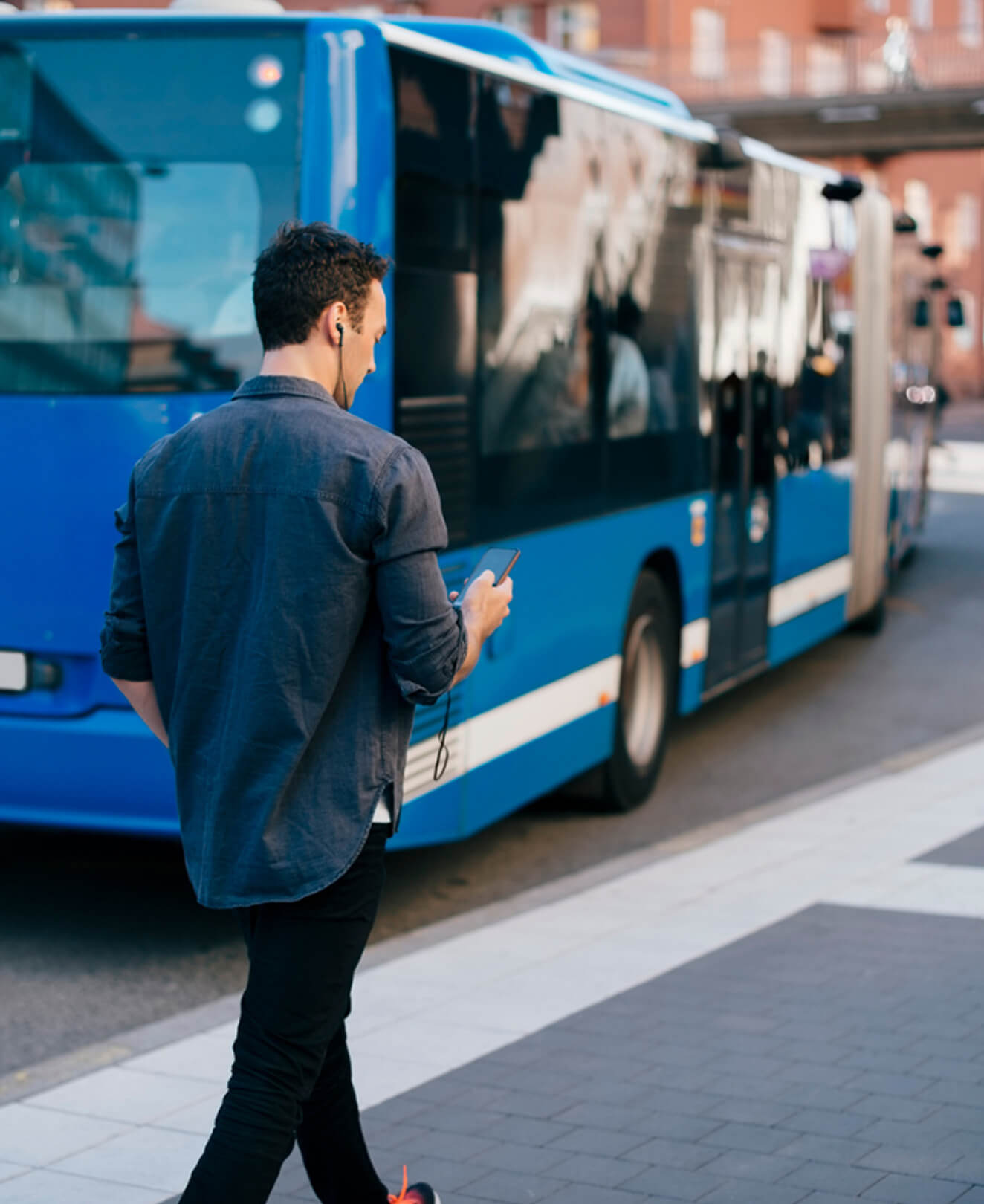 Person boarding a blue city bus – real-world application of data from Flowmapper