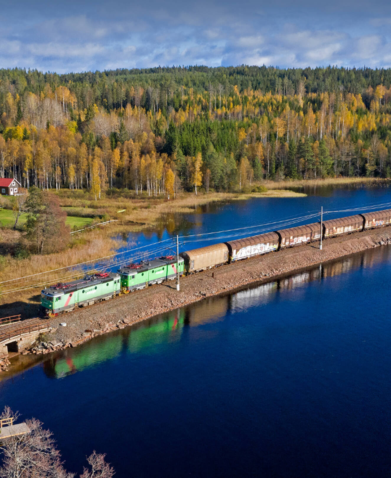 Train running through autumn landscape – onboard QTMS system enabling continuous track monitoring