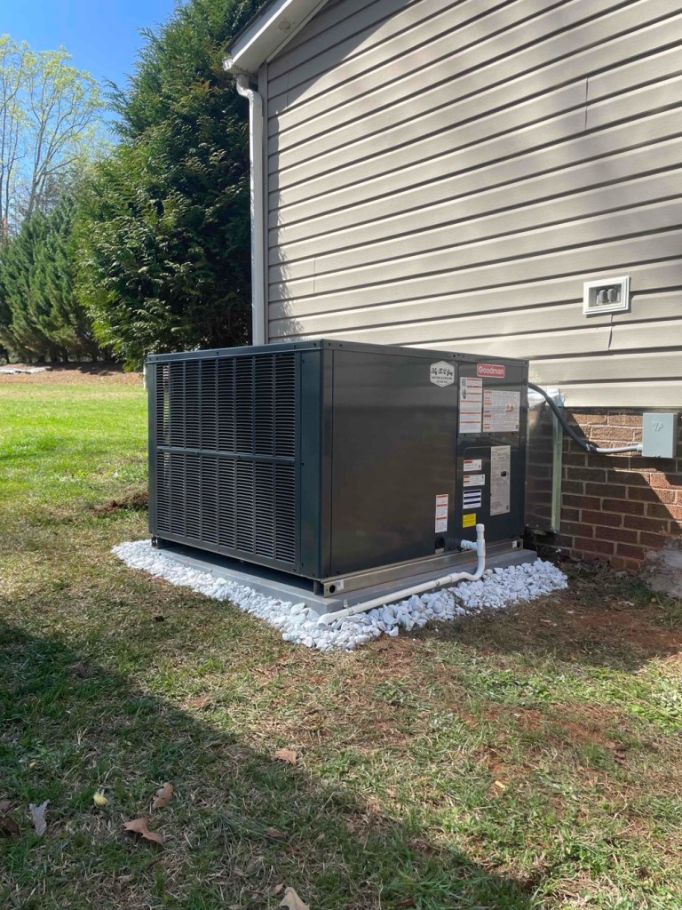 HVAC technician giving thumbs up inside house frame