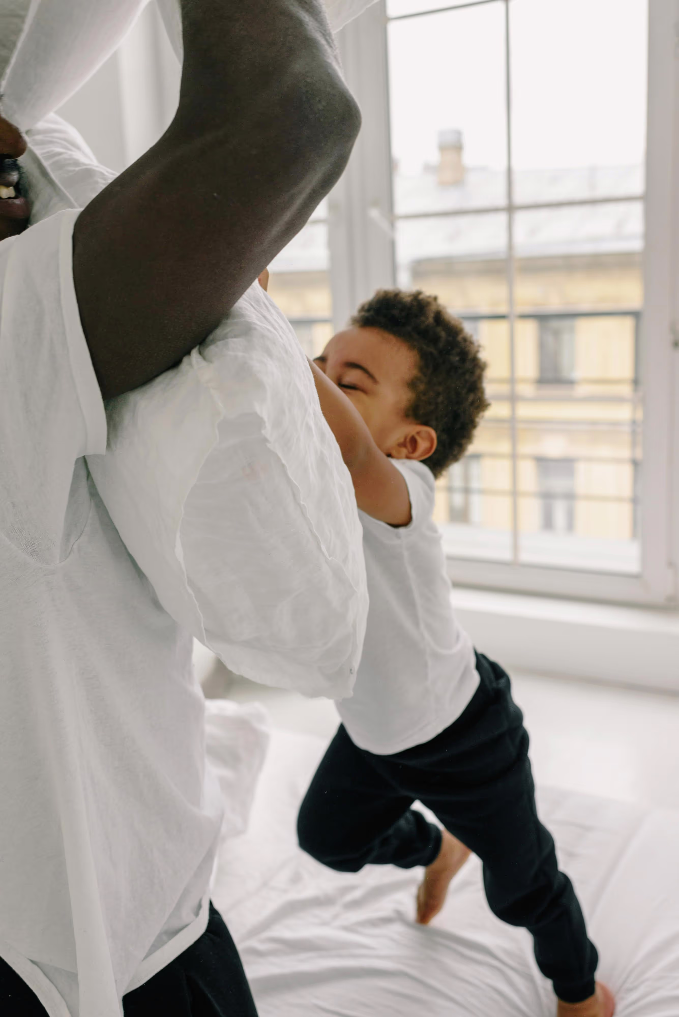 A father and son having a pillow fight.