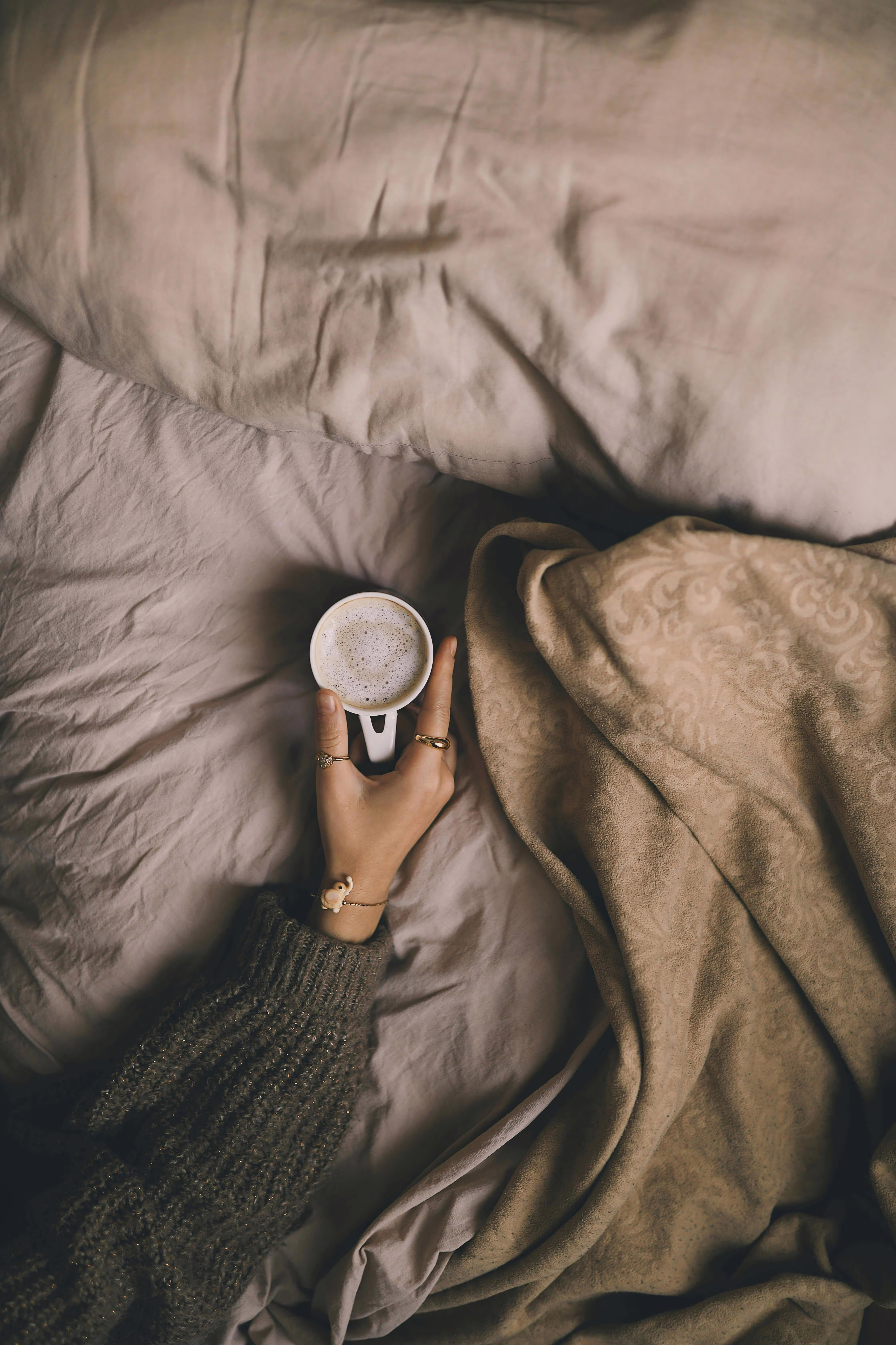 A cup of coffee in bed.