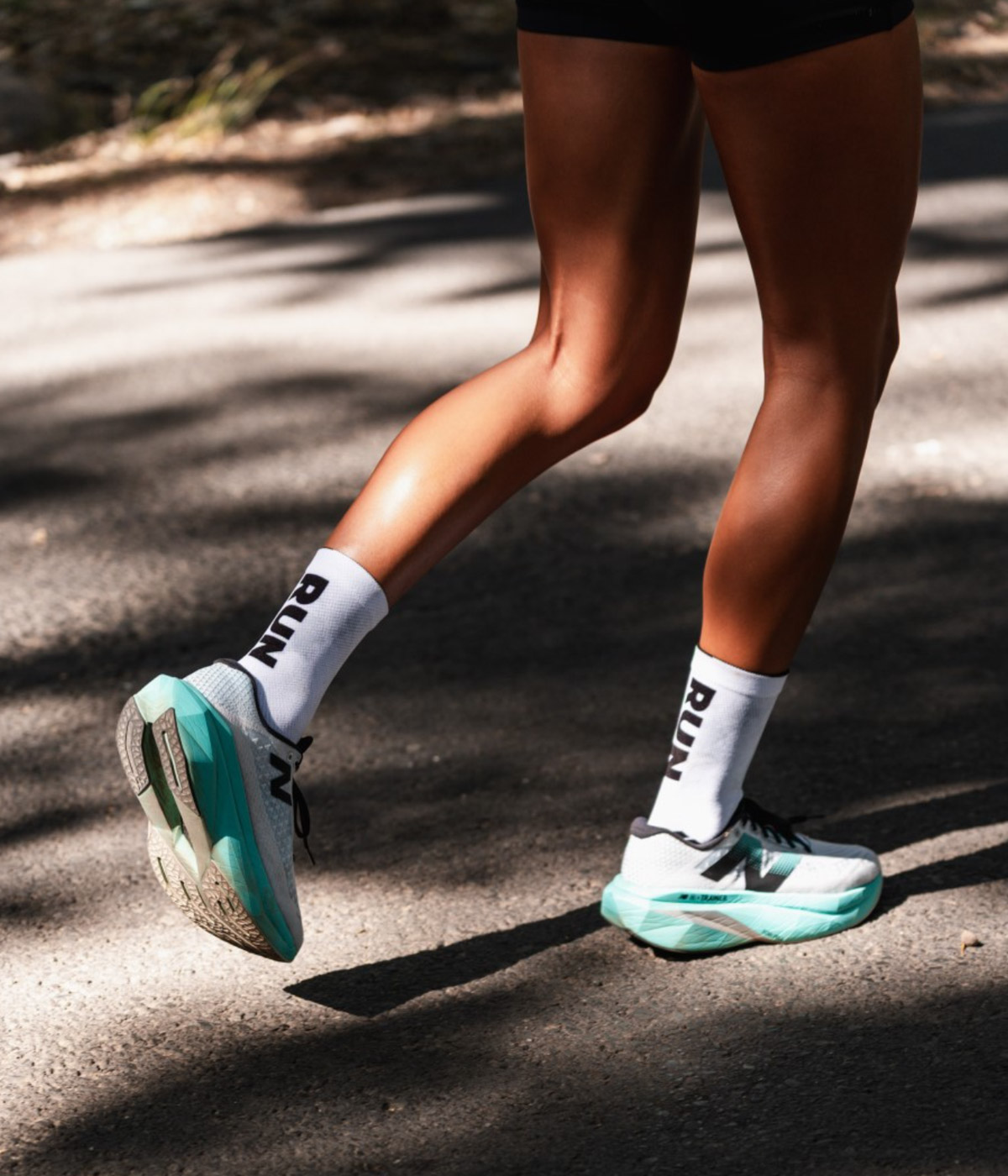 A runner wearing white Versus Socks.