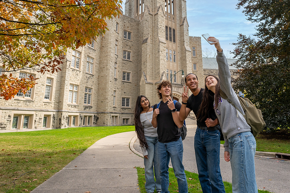 Students taking a selfie in front of building at Western University.