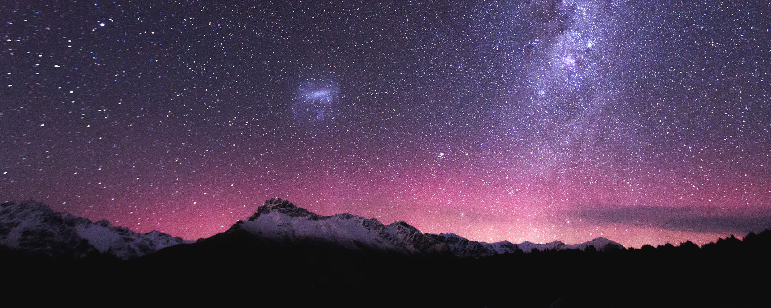 Night sky with mountains and a sky full of stars.