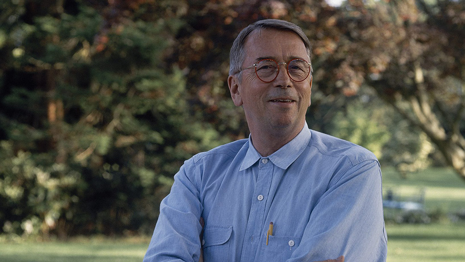Bill Hodgins standing with trees in background.