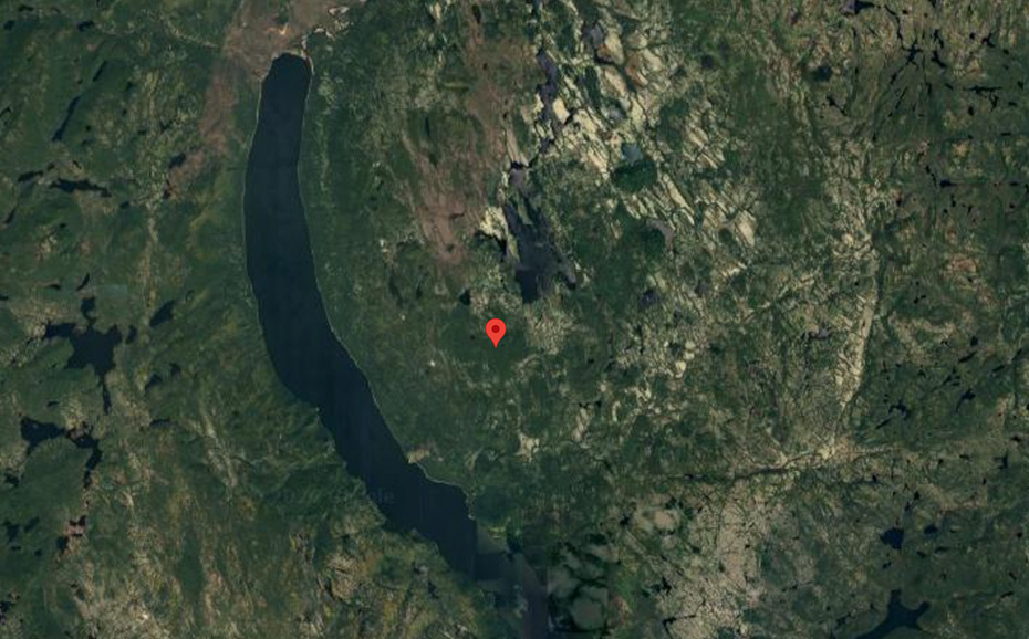 Google Maps satellite view screenshot with a red pin in the center