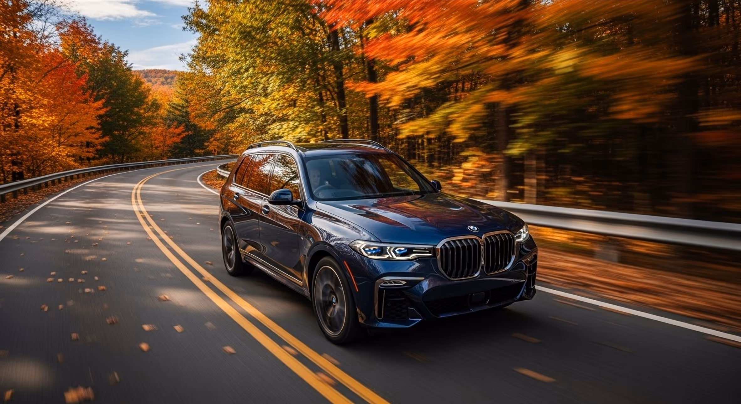 A car driving on a road in autumn