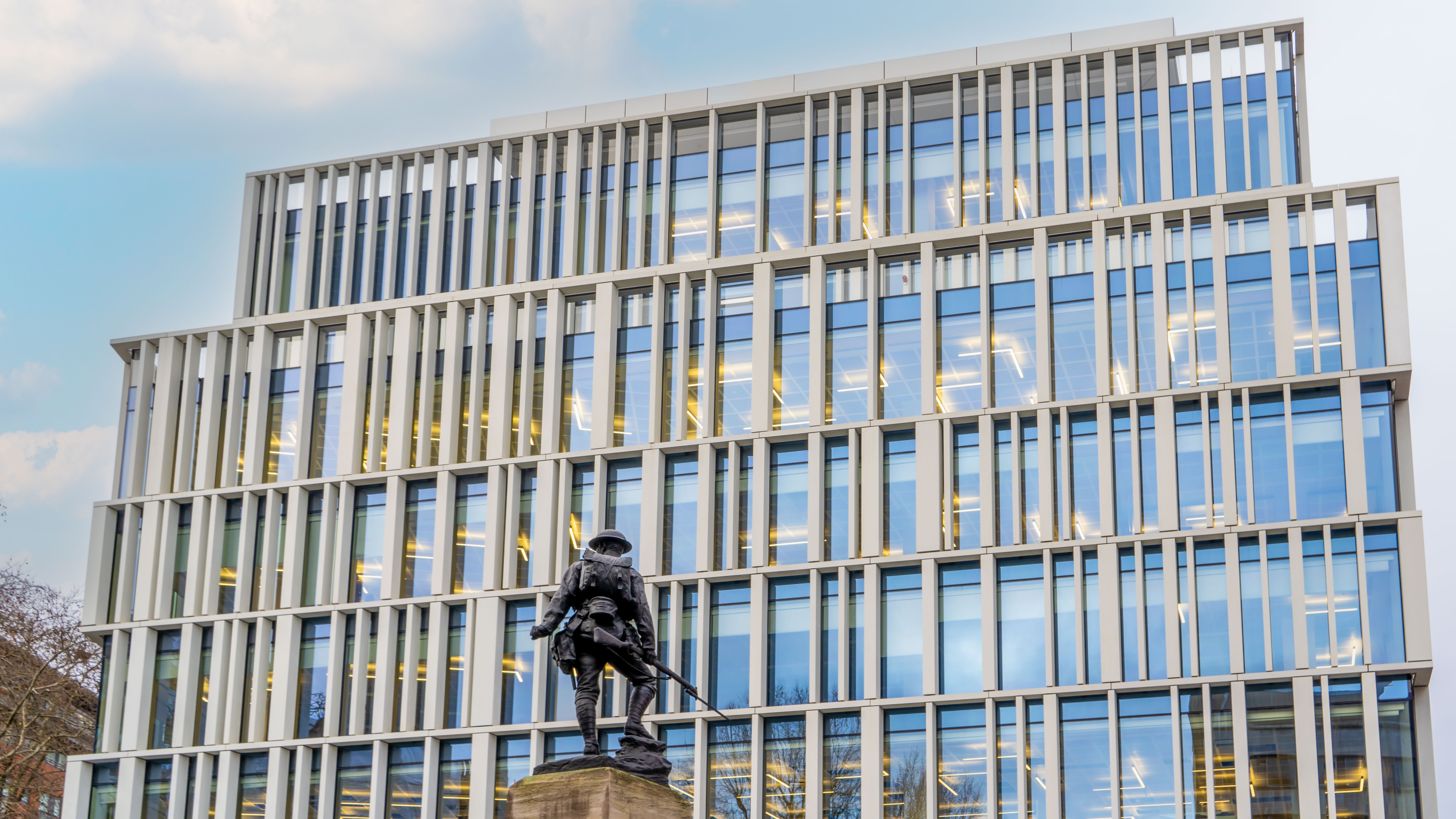 150 Holborn, a white-finned office building with a statue in the foreground