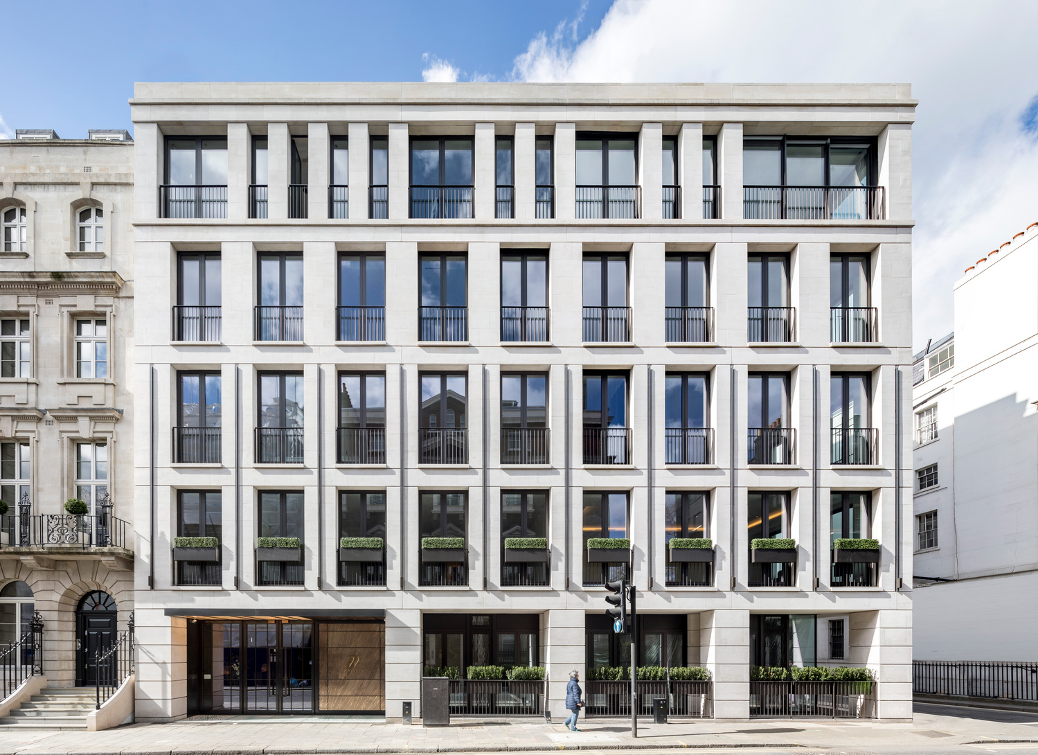 Front elevation of 77 Mayfair, a pale stone building with tall windows