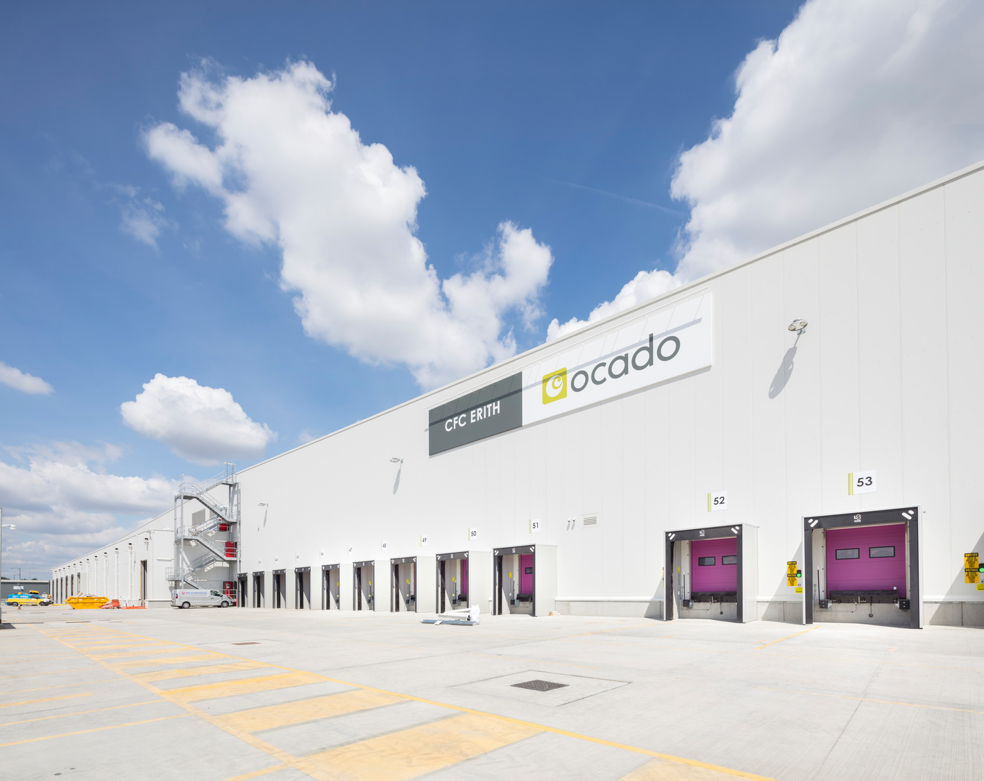 Ocado distribution centre in Erith, a large white warehouse with loading bays