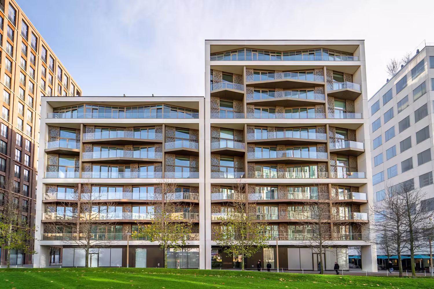 Luma R3 residential block with balconies facing a green lawn at King's Cross