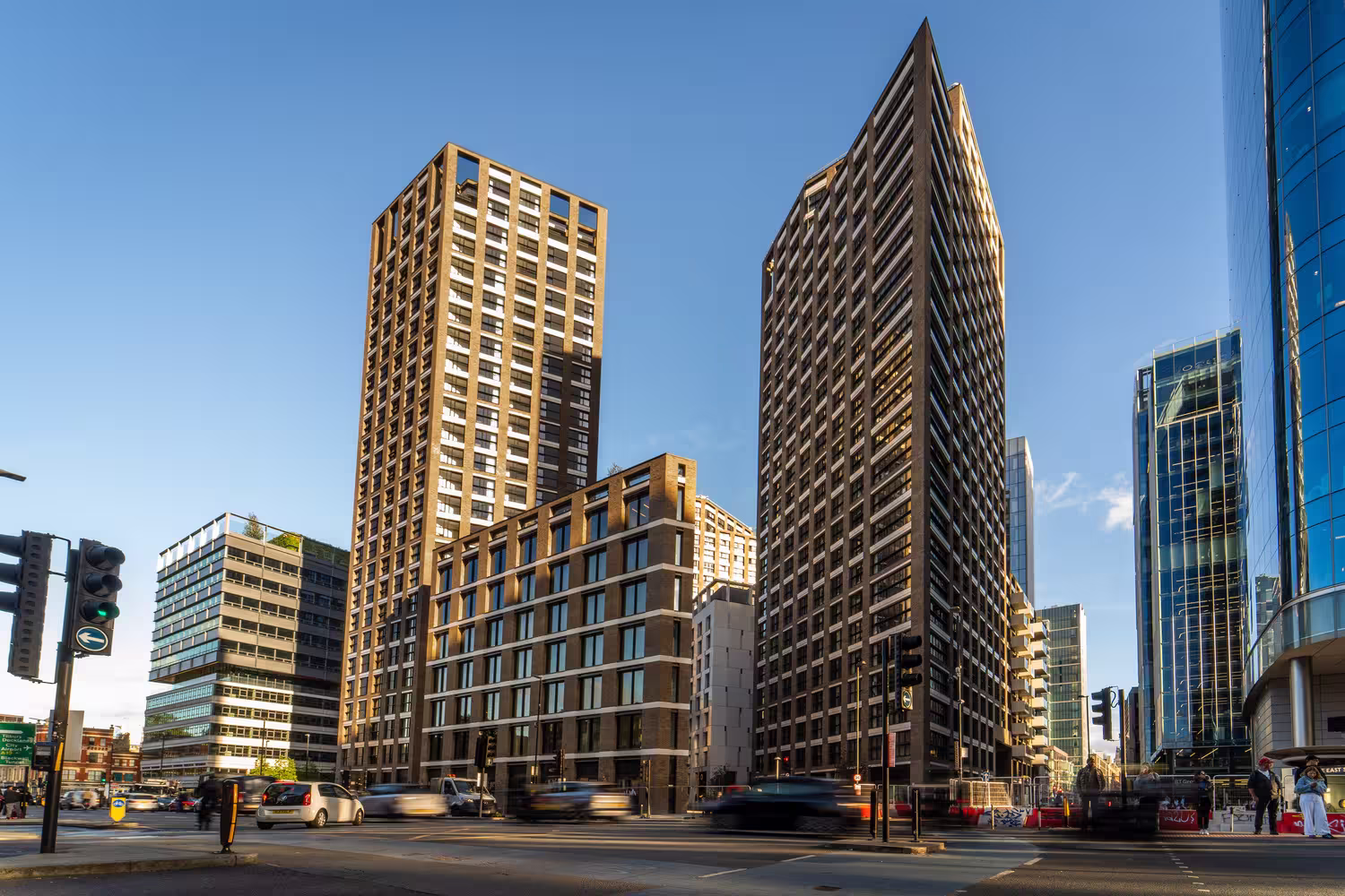 Aldgate Place Phase 2 towers seen from a busy street junction in Aldgate