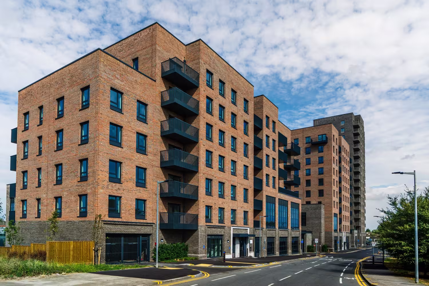 Brick residential blocks at 12 Thames Road in Barking, with a taller block behind