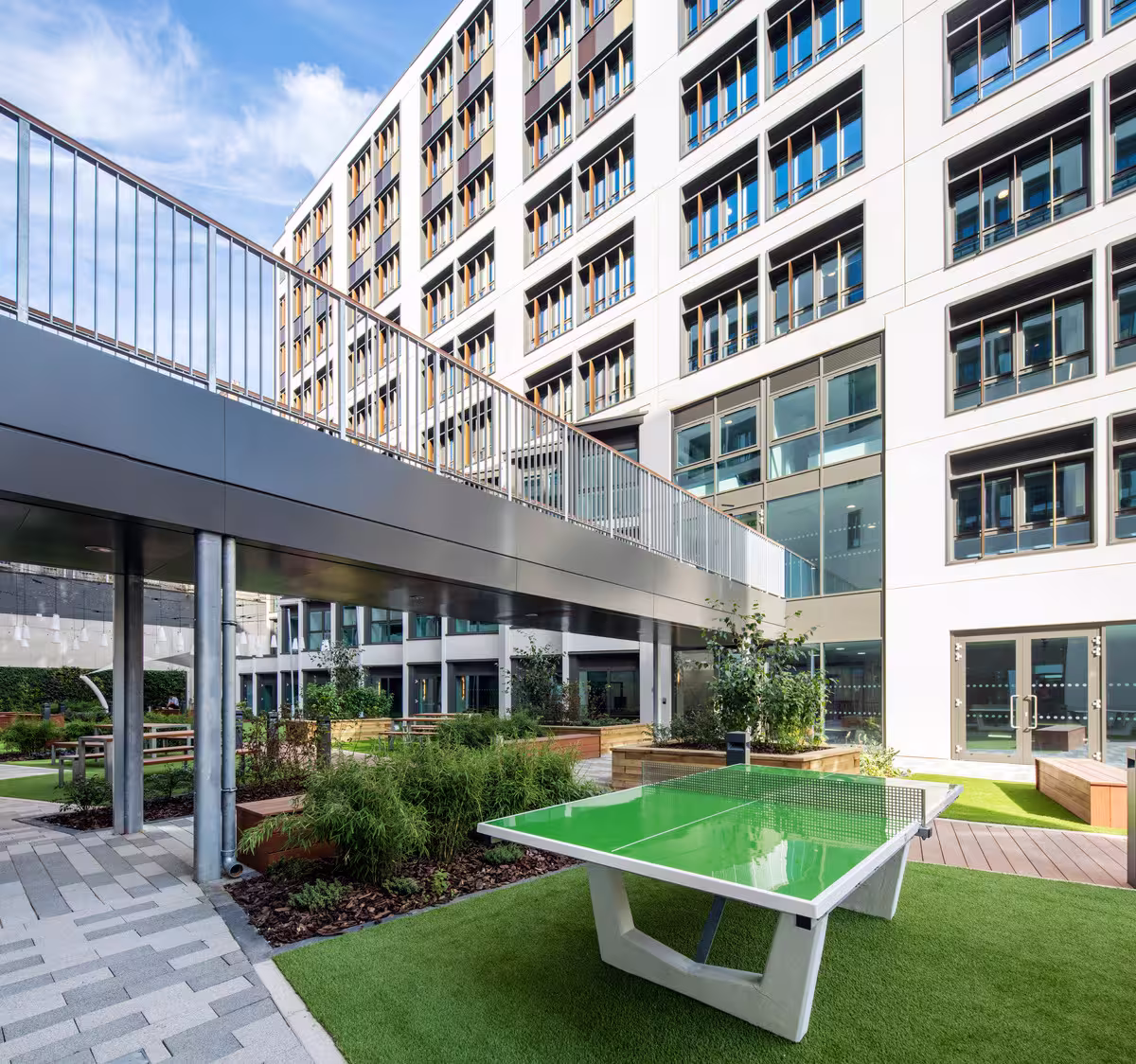 Landscaped courtyard at Paul Street with a table tennis table beneath student accommodation blocks