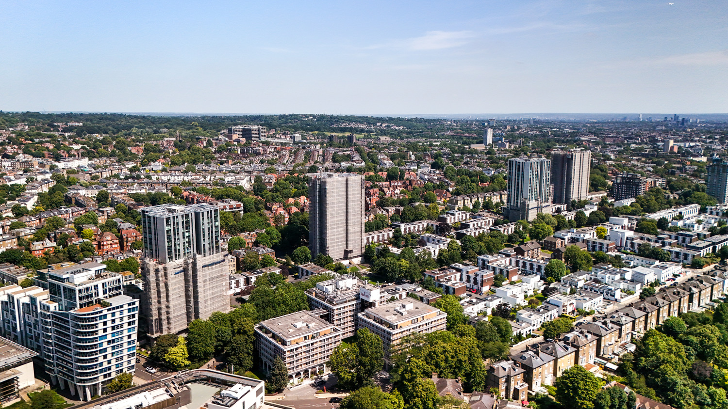 Aerial view over Swiss Cottage showing the re-clad Chalcots Estate towers among surrounding streets