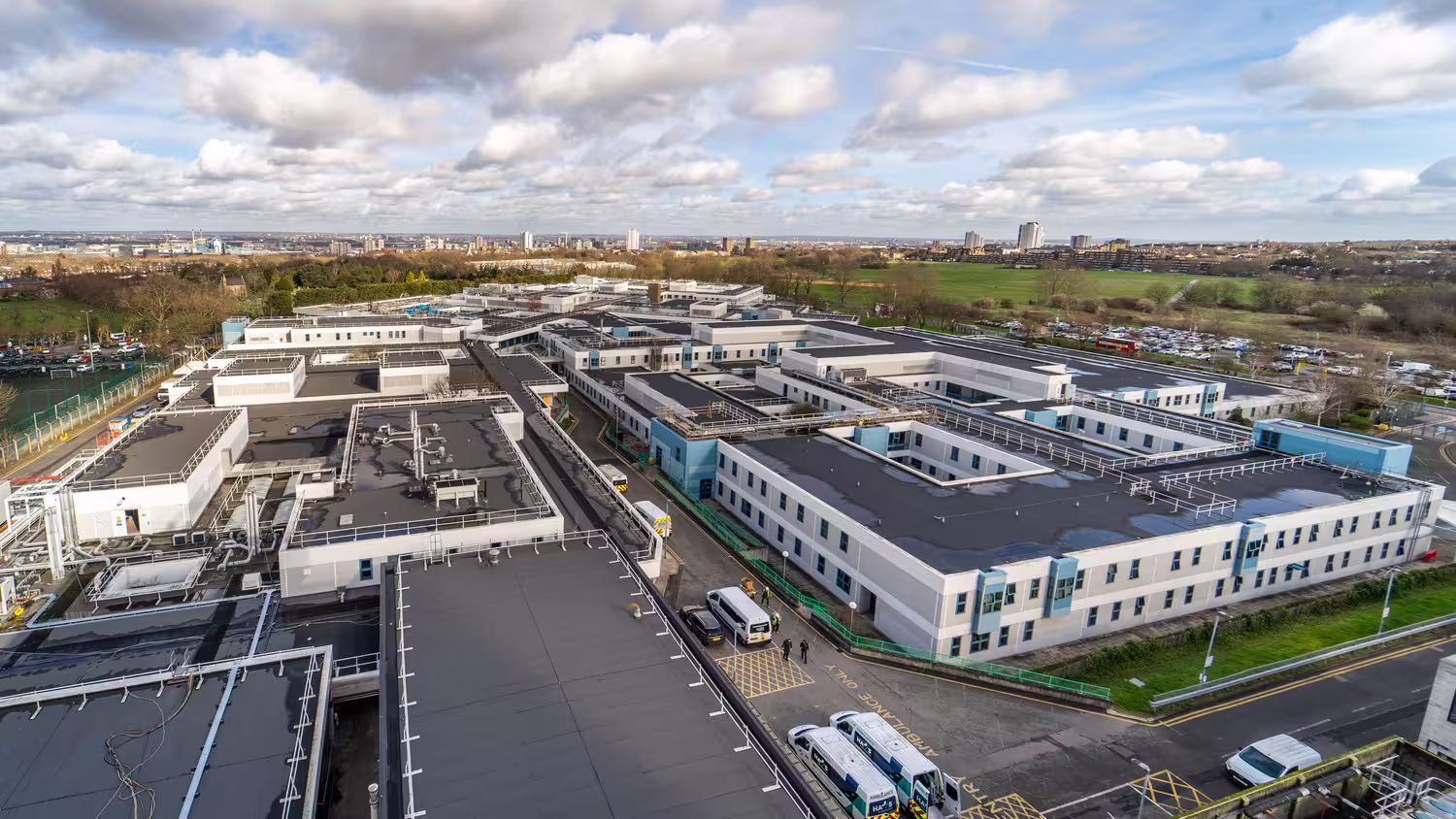Aerial view of Queen Elizabeth Hospital in Woolwich, with its low-rise ward blocks and rooftop plant