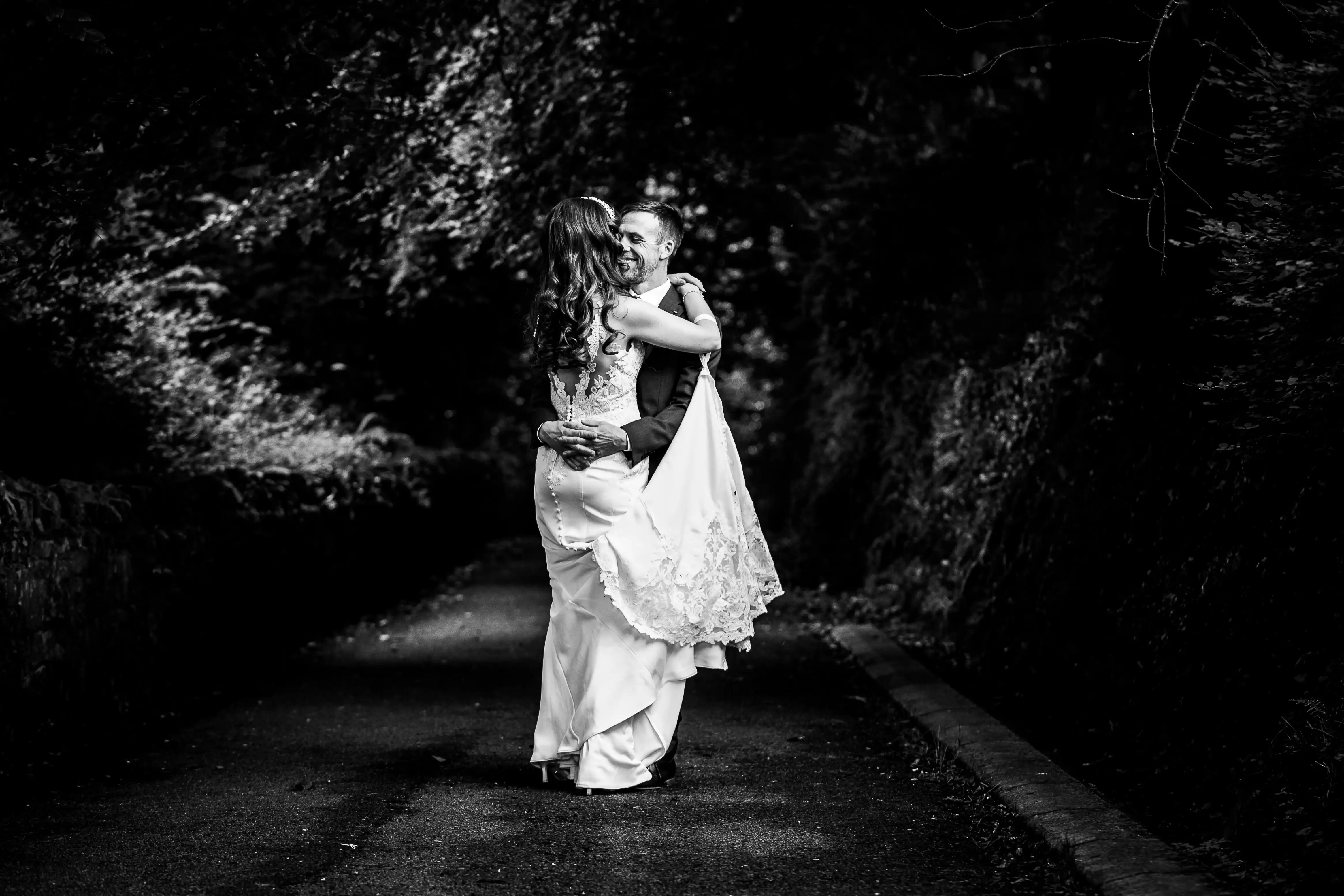 Newly married couple embracing each other in nature