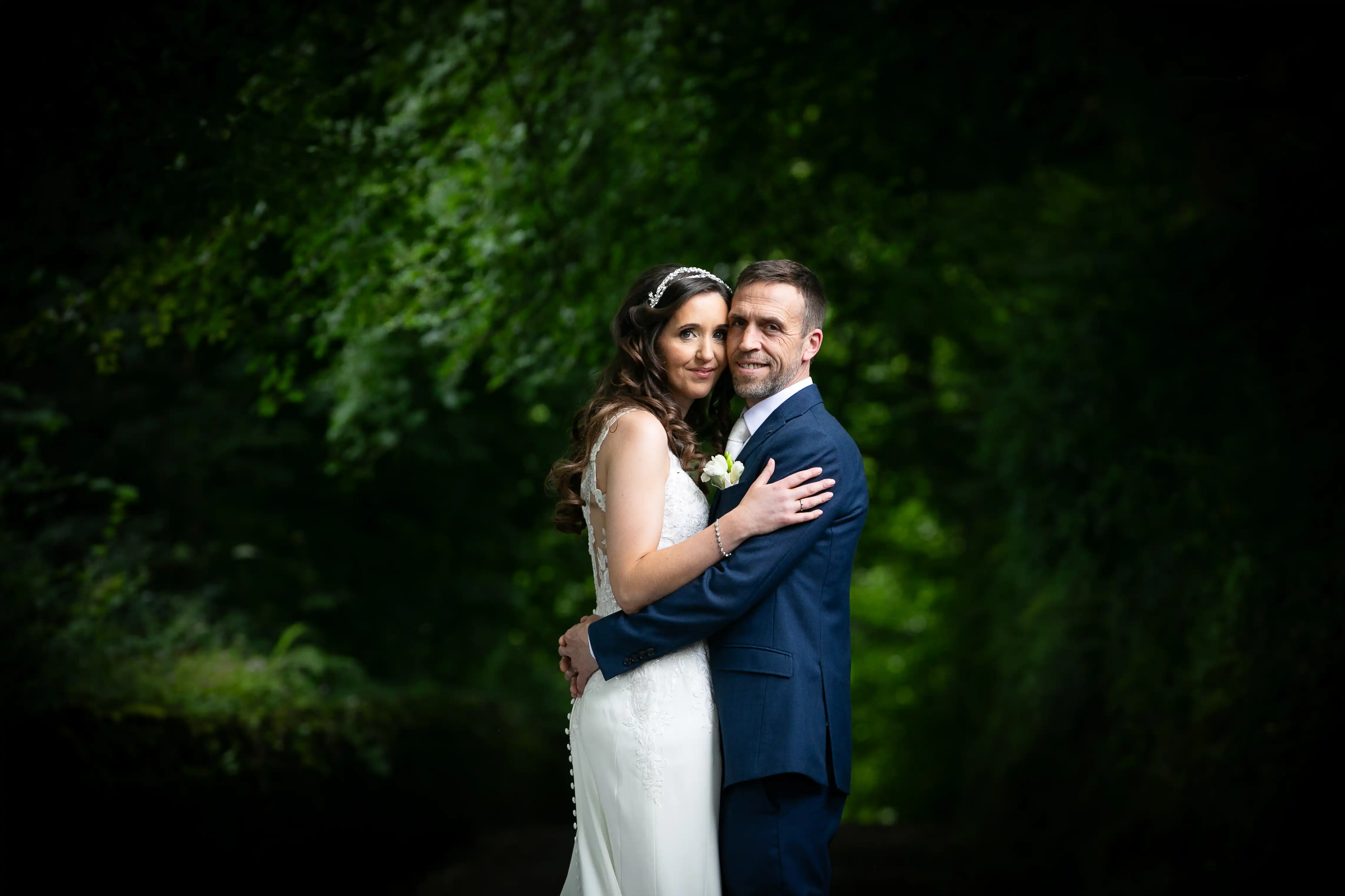 Bride and groom posing for photo in nature
