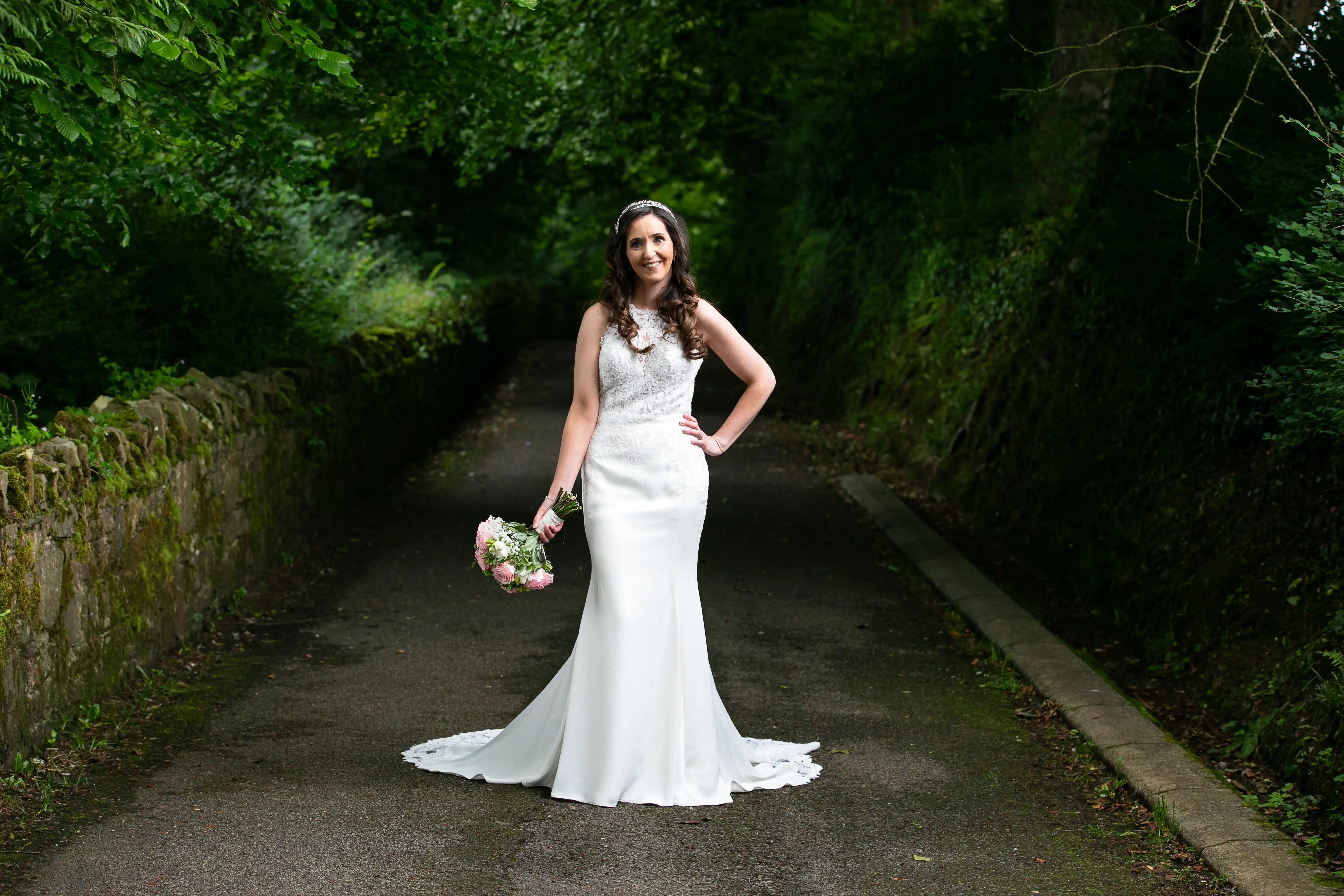 Bride posing for photo in nature