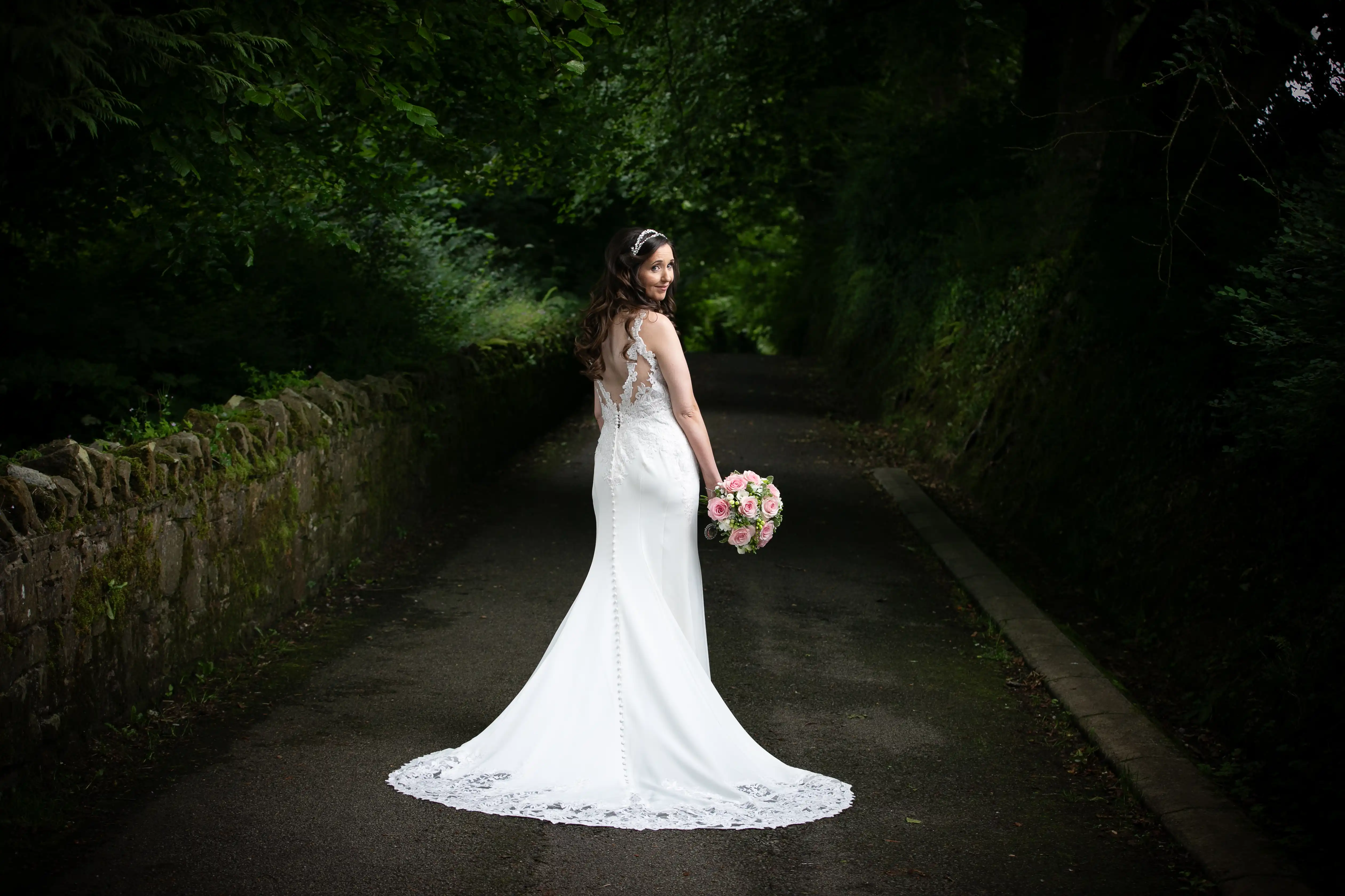 Bride posing for photo in nature
